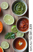 A food stylist's workspace with bowls of vibrant sauces. bright green herb pesto, deep red harissa, golden turmeric aioli arranged on beautiful modern kitchen. Стоковое AI-видео, аниматор Sergey Grishin / Фотобанк Лори