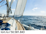 Sailing boat deck with hoisted sails and teak deck. Стоковое фото, агентство Ingram Publishing / Фотобанк Лори