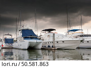 Yacht and boats docking at the marina before the storm comes. Стоковое фото, агентство Ingram Publishing / Фотобанк Лори