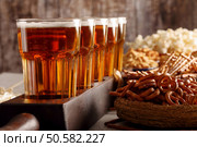 Beer and snacks on wooden background football fan set. Стоковое фото, агентство Ingram Publishing / Фотобанк Лори