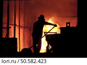 steel worker takes a sample from oven. Стоковое фото, агентство Ingram Publishing / Фотобанк Лори
