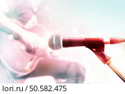 Abstract colorful microphone with guitarist on stage, pastel color and soft concept. Стоковое фото, агентство Ingram Publishing / Фотобанк Лори