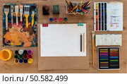 Painter workplace top view photo. Artist paintbrushes, colorful paints and crayons assorted on the desk. Painter workplace top view photo. Artist paintbrushes, colorful paints and crayons assorted on the desk. Стоковое фото, агентство Ingram Publishing / Фотобанк Лори