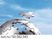Last piece of a global puzzle concept for business solutions and strategy. Стоковое фото, агентство Ingram Publishing / Фотобанк Лори