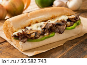 A delicious oven bake steak and cheese submarine sandwich with mushrooms, green peppers, and onion. Стоковое фото, агентство Ingram Publishing / Фотобанк Лори