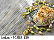 eastern traditional dessert with nuts wooden sample text background. Стоковое фото, агентство Ingram Publishing / Фотобанк Лори