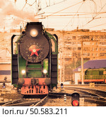 Retro steam train moves on the station at sunset.. Retro steam train. Стоковое фото, агентство Ingram Publishing / Фотобанк Лори