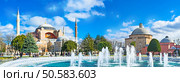 Panoramic view of the Hagia Sophia and Ayasofya Hurrem Sultan Hamam from the Sultanahmet park, Istanbul, Turkey. Стоковое фото, агентство Ingram Publishing / Фотобанк Лори