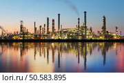 Oil and gas refinery at twilight with reflection - factory - petrochemical plant. Стоковое фото, агентство Ingram Publishing / Фотобанк Лори
