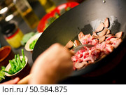 Chef cooking vegetables and meat in wok pan. Стоковое фото, агентство Ingram Publishing / Фотобанк Лори