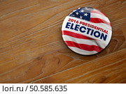3D illustration of a political button for the US presidential election in 2016 on wooden surface. Редакционное фото, агентство Ingram Publishing / Фотобанк Лори