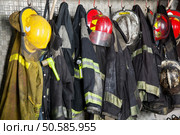 Firefighter suits and helmets hanging at fire station. Firefighter's Gear Hanging At Fire Station. Стоковое фото, агентство Ingram Publishing / Фотобанк Лори