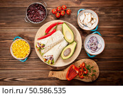 Traditional mexican tortilla wrap with a mix of ingredients. Tortilla with a mix of ingredients. Стоковое фото, агентство Ingram Publishing / Фотобанк Лори