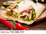 Traditional mexican tortilla wrap with a mix of ingredients. Tortilla with a mix of ingredients. Стоковое фото, агентство Ingram Publishing / Фотобанк Лори