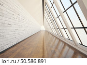 Clean corridor interior with dark wooden floor, light wall, concrete ceiling and panoramic window. 3D Rendering. Стоковое фото, агентство Ingram Publishing / Фотобанк Лори