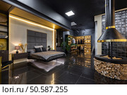 dark modern stylish male apartment interior with lighting, decorative walls, fireplace, dressing area and huge window. Стоковое фото, агентство Ingram Publishing / Фотобанк Лори