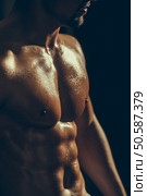 sexy muscular male torso six packs on wet body of athletic man training with bare chest and strong biceps on hands, closeup. muscular male wet torso. Стоковое фото, агентство Ingram Publishing / Фотобанк Лори
