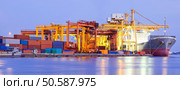 Panorama of Industrial Container Cargo freight ship with working crane bridge in shipyard at dusk for Logistic Import Export background. Стоковое фото, агентство Ingram Publishing / Фотобанк Лори