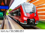 Railroad travel and railway tourism transportation industrial concept: scenic summer view of modern high speed passenger commuter train on tracks at the station platform with motion blur effect. Стоковое фото, агентство Ingram Publishing / Фотобанк Лори