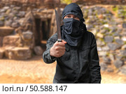 Terrorism concept. Terrorist threatening with knife. Стоковое фото, агентство Ingram Publishing / Фотобанк Лори