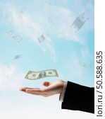 US Dollars floating in air above businessman’s hand. 24316768. Стоковое фото, агентство Ingram Publishing / Фотобанк Лори