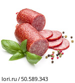 Salami smoked sausage, basil leaves and peppercorns isolated on white background cutout. Стоковое фото, агентство Ingram Publishing / Фотобанк Лори