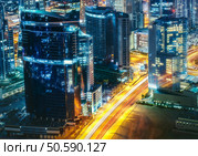 Fantastic rooftop view of a big modern city architecture at night with roads. Business bay, Dubai, United Arab Emirates. Стоковое фото, агентство Ingram Publishing / Фотобанк Лори