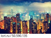 Scenic view over Hong Kong, China, by night. Nighttime skyline with illuminated skyscrapers seen from Victoria Peak. Стоковое фото, агентство Ingram Publishing / Фотобанк Лори