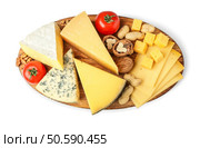Board with assortment of delicious cheese, tomatoes and nuts on white background. Стоковое фото, агентство Ingram Publishing / Фотобанк Лори