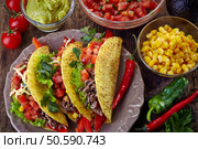 Plate of Mexican food Tacos on old wooden table. Стоковое фото, агентство Ingram Publishing / Фотобанк Лори