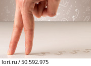 Female fingers walking on white surface with bare footsteps behind them and white scribbles in the background. Стоковое фото, агентство Ingram Publishing / Фотобанк Лори