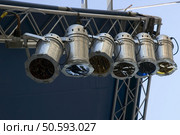 Six stage lights with color gel filters hanging by corner of outdoor stage. Стоковое фото, агентство Ingram Publishing / Фотобанк Лори
