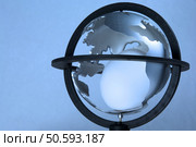 Egg inside model globe of Earth. Стоковое фото, агентство Ingram Publishing / Фотобанк Лори