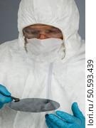 Inspecting a Silicon Wafer Wearing Hazmat Suit. Стоковое фото, агентство Ingram Publishing / Фотобанк Лори