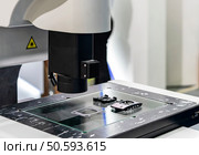 workpiece during inspection dimension shape appearance etc. by high technology precision video measuring machine with visual camera for quality control of manufacturing process. Стоковое фото, агентство Ingram Publishing / Фотобанк Лори