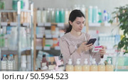 European woman uses mobile phone to scan the barcode on a box of paracetamol. Buyer at the pharmacy pays for medicines and pills with to qr code. Стоковое видео, видеограф Яков Филимонов / Фотобанк Лори