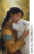 Native american woman embracing white wolf in autumn forest. Стоковое AI-видео, аниматор Юрий Поздников / Фотобанк Лори