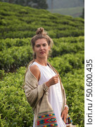 Woman Explorer Experiences Serenity Among Lush Tea Plantations in a Picturesque Outdoor Setting. Стоковое фото, фотограф Aleksandr Golubev / Фотобанк Лори