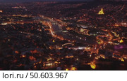 View from copter of illuminated center of Tbilisi city in the evening, Georgia. Стоковое видео, видеограф Яков Филимонов / Фотобанк Лори