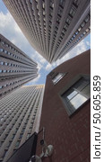 Skyscrapers from below against a blue sky, capturing an urban architectural perspective. Стоковое видео, видеограф Анастасия Золотницкая / Фотобанк Лори