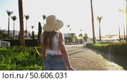 A woman goes to the beach to the sea on the hotel territory. Стоковое видео, видеограф Igor Skripachev / Фотобанк Лори