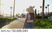 A woman goes to the beach to the sea on the hotel territory. Стоковое видео, видеограф Igor Skripachev / Фотобанк Лори
