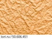 Intensely crumpled brown wrapping paper creating a chaotic abstract texture, an ideal expressive grunge background for dramatic and bold design projects. Стоковое фото, фотограф Павел Муравьев / Фотобанк Лори