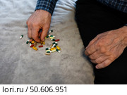 Man preparing medication on a soft surface at home during the afternoon. Стоковое фото, фотограф Вербицкая Светлана / Фотобанк Лори