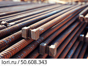 Stack of rusty reinforcing bars for construction showing its spiral texture. Стоковое AI-изображение, AI-художник Иван Рябоконь / Фотобанк Лори