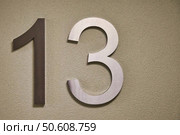 Thirteen Numeric Figure Attached to Exterior Wall on a Sunny Day. Стоковое фото, фотограф Aleksandr Golubev / Фотобанк Лори