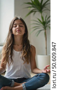 Girl with long hair and in jeans meditating in a lotus pose. Стоковое AI-видео, аниматор Sergey Grishin / Фотобанк Лори