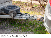 A car hitch is connected to a trailer whose spare tires are attached to the trailer frame. Стоковое фото, фотограф Коханова Наталья / Фотобанк Лори
