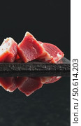 Pieces of raw fresh meat isolated on black on stone board mirrored side view. Стоковое AI-видео, аниматор Sergey Grishin / Фотобанк Лори