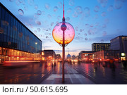Soap bubbles floating over potsdamer platz with tv tower in berlin at dusk. Стоковое AI-изображение, AI-художник Иван Рябоконь / Фотобанк Лори